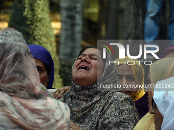 Women mourn over the body of Doctor Shahnawaz Ahmad Dar during his funeral ceremony in his native village in Nadigam in central Kashmir's Bu...