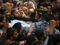 People carry the dead body of Doctor Shahnawaz Ahmad Dar during his funeral ceremony at his native village in Nadigam in central Kashmir's B...