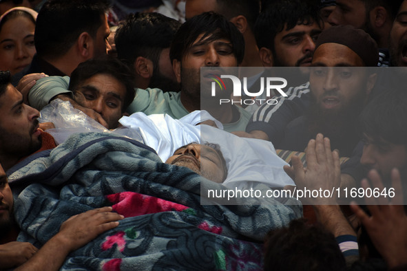 People carry the dead body of Doctor Shahnawaz Ahmad Dar during his funeral ceremony at his native village in Nadigam in central Kashmir's B...