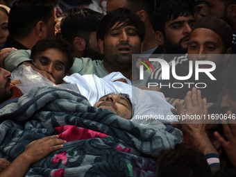 People carry the dead body of Doctor Shahnawaz Ahmad Dar during his funeral ceremony at his native village in Nadigam in central Kashmir's B...