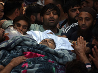 People carry the dead body of Doctor Shahnawaz Ahmad Dar during his funeral ceremony at his native village in Nadigam in central Kashmir's B...