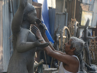 An artist works on a semi-finished clay idol of the Hindu goddess Kali in Siliguri, India, on October 21, 2024. The worship of the Hindu dei...