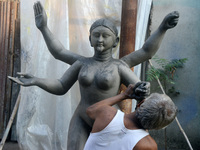 An artist works on a semi-finished clay idol of the Hindu goddess Kali in Siliguri, India, on October 21, 2024. The worship of the Hindu dei...