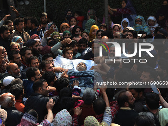 People carry the dead body of Doctor Shahnawaz Ahmad Dar during his funeral ceremony at his native village in Nadigam in central Kashmir's B...