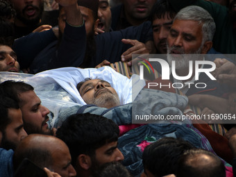 People carry the dead body of Doctor Shahnawaz Ahmad Dar during his funeral ceremony at his native village in Nadigam in central Kashmir's B...