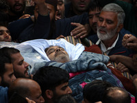 People carry the dead body of Doctor Shahnawaz Ahmad Dar during his funeral ceremony at his native village in Nadigam in central Kashmir's B...