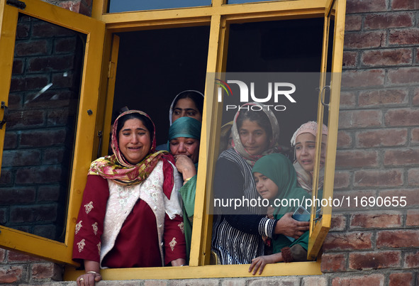 Relatives mourn over the body of Doctor Shahnawaz Ahmad Dar during his funeral ceremony at his native village in Nadigam in central Kashmir'...