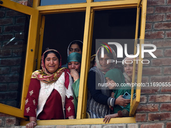 Relatives mourn over the body of Doctor Shahnawaz Ahmad Dar during his funeral ceremony at his native village in Nadigam in central Kashmir'...