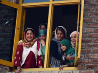 Relatives mourn over the body of Doctor Shahnawaz Ahmad Dar during his funeral ceremony at his native village in Nadigam in central Kashmir'...