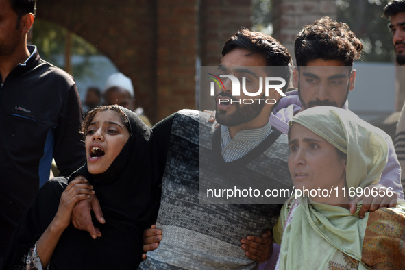 In Budgam, Kashmir, India, on October 21, 2024, Brother (C) mourns over the dead body of Doctor Shahnawaz Ahmad Dar during his funeral cerem...