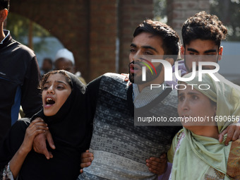 In Budgam, Kashmir, India, on October 21, 2024, Brother (C) mourns over the dead body of Doctor Shahnawaz Ahmad Dar during his funeral cerem...