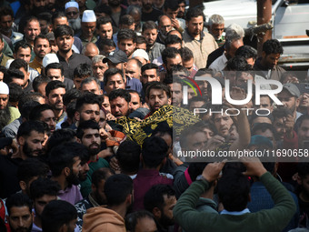 People carry the dead body of Doctor Shahnawaz Ahmad Dar during his funeral ceremony at his native village in Nadigam in central Kashmir's B...