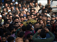 People carry the dead body of Doctor Shahnawaz Ahmad Dar during his funeral ceremony at his native village in Nadigam in central Kashmir's B...