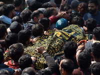 People carry the dead body of Doctor Shahnawaz Ahmad Dar during his funeral ceremony at his native village in Nadigam in central Kashmir's B...