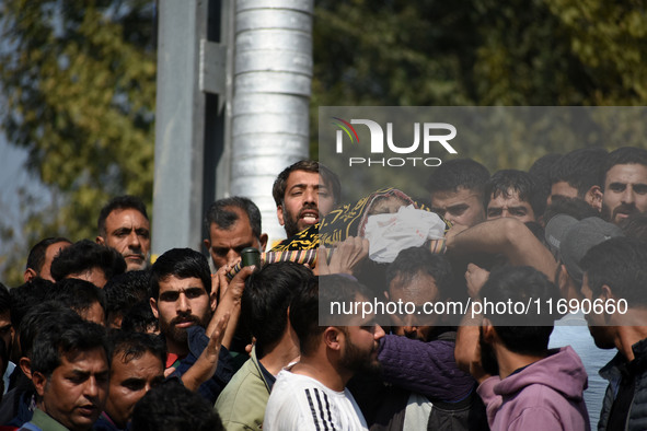 People carry the dead body of Doctor Shahnawaz Ahmad Dar during his funeral ceremony at his native village in Nadigam in central Kashmir's B...