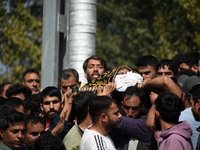 People carry the dead body of Doctor Shahnawaz Ahmad Dar during his funeral ceremony at his native village in Nadigam in central Kashmir's B...