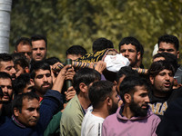 People carry the dead body of Doctor Shahnawaz Ahmad Dar during his funeral ceremony at his native village in Nadigam in central Kashmir's B...