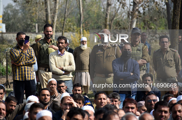 Indian policemen are seen near the body of Doctor Shahnawaz Ahmad Dar during his funeral ceremony at his native village in Nadigam in centra...