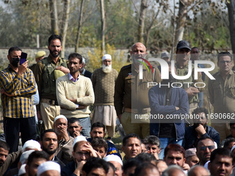 Indian policemen are seen near the body of Doctor Shahnawaz Ahmad Dar during his funeral ceremony at his native village in Nadigam in centra...