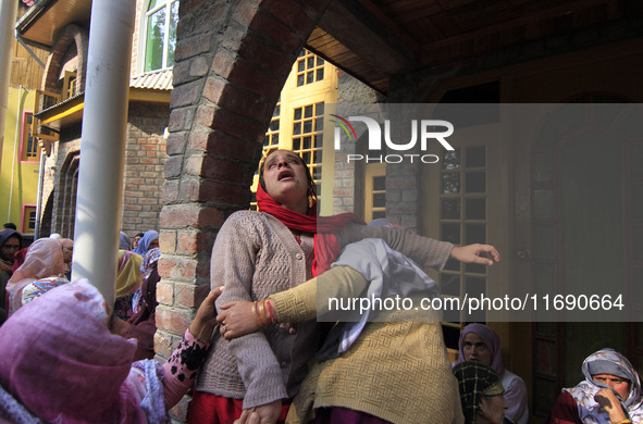 In Budgam, Kashmir, India, on October 21, 2024, a sister mourns over the dead body of Doctor Shahnawaz Ahmad Dar during his funeral ceremony...