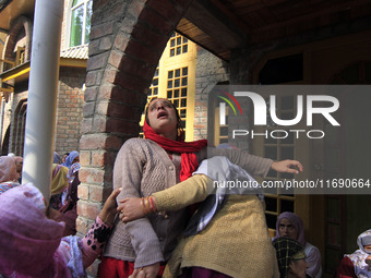 In Budgam, Kashmir, India, on October 21, 2024, a sister mourns over the dead body of Doctor Shahnawaz Ahmad Dar during his funeral ceremony...