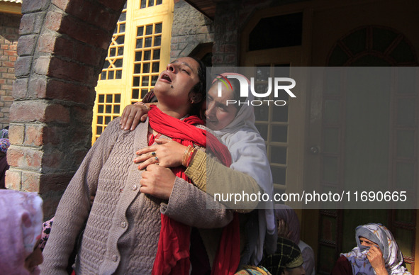 In Budgam, Kashmir, India, on October 21, 2024, a sister mourns over the dead body of Doctor Shahnawaz Ahmad Dar during his funeral ceremony...