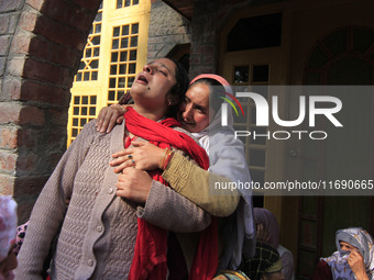 In Budgam, Kashmir, India, on October 21, 2024, a sister mourns over the dead body of Doctor Shahnawaz Ahmad Dar during his funeral ceremony...