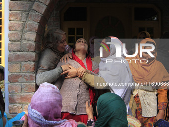 In Budgam, Kashmir, India, on October 21, 2024, a sister mourns over the dead body of Doctor Shahnawaz Ahmad Dar during his funeral ceremony...