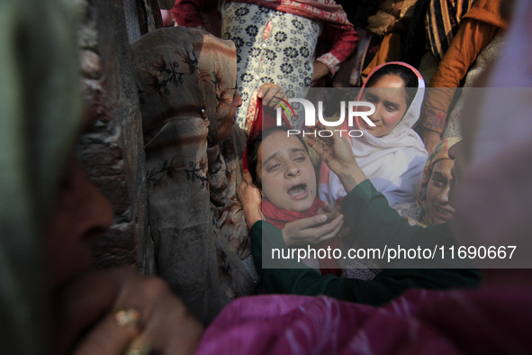 In Budgam, Kashmir, India, on October 21, 2024, a sister mourns over the dead body of Doctor Shahnawaz Ahmad Dar during his funeral ceremony...