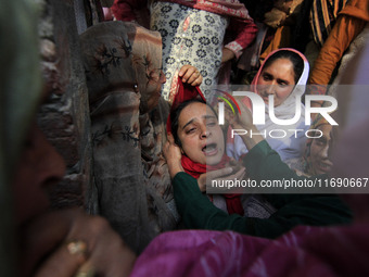 In Budgam, Kashmir, India, on October 21, 2024, a sister mourns over the dead body of Doctor Shahnawaz Ahmad Dar during his funeral ceremony...