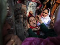 In Budgam, Kashmir, India, on October 21, 2024, a sister mourns over the dead body of Doctor Shahnawaz Ahmad Dar during his funeral ceremony...