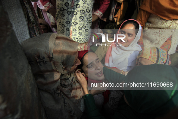 In Budgam, Kashmir, India, on October 21, 2024, a sister mourns over the dead body of Doctor Shahnawaz Ahmad Dar during his funeral ceremony...