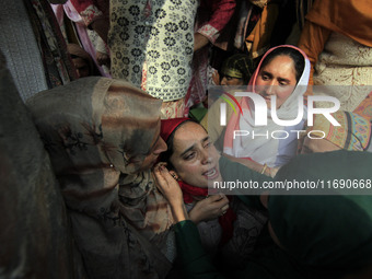 In Budgam, Kashmir, India, on October 21, 2024, a sister mourns over the dead body of Doctor Shahnawaz Ahmad Dar during his funeral ceremony...