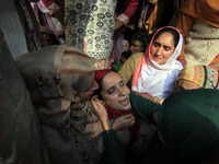 In Budgam, Kashmir, India, on October 21, 2024, a sister mourns over the dead body of Doctor Shahnawaz Ahmad Dar during his funeral ceremony...