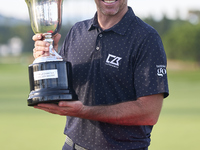 Julien Guerrier of France poses with the trophy on the 18th green after winning a nine-hole play-off on day four of the Estrella Damm N.A. A...