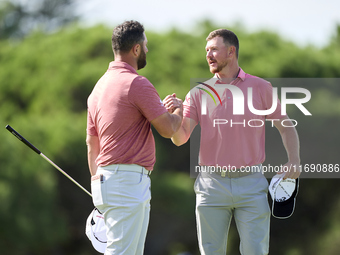 Jon Rahm of Spain greets Jacques Kruyswijk of South Africa at the end of day four of the Estrella Damm N.A. Andalucia Masters 2024 at Real C...