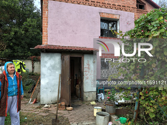 A woman stands outside a house damaged by the October 18 Russian missile strike in Odesa, Ukraine, on October 19, 2024. NO USE RUSSIA. NO US...