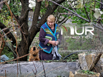 A woman and a dog are near a building damaged by the October 18 Russian missile strike in Odesa, Ukraine, on October 19, 2024. NO USE RUSSIA...