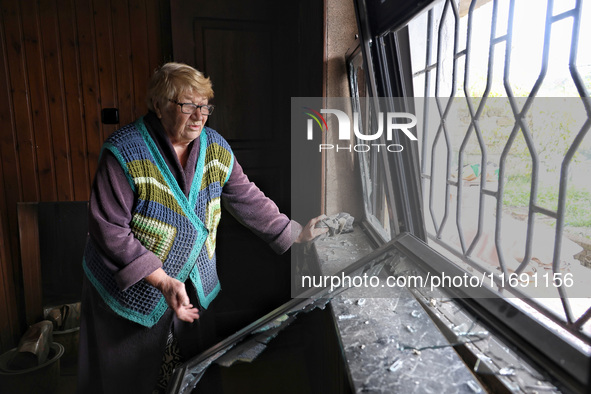 A woman stands by a smashed window after the October 18 Russian missile strike in Odesa, Ukraine, on October 19, 2024. NO USE RUSSIA. NO USE...