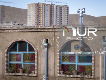 A housing complex is visible behind an Iranian traditional restaurant in the southern suburb of the historical city of Tabriz, located 624 k...