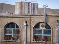 A housing complex is visible behind an Iranian traditional restaurant in the southern suburb of the historical city of Tabriz, located 624 k...