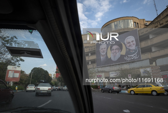 A banner featuring portraits of the IRGC's Quds Force former commander, General Qassem Soleimani, Lebanon's Hezbollah late leader, Hassan Na...