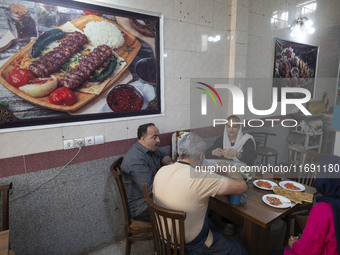 An Iranian family eats breakfast at a small restaurant in the historical city of Tabriz, located 624 km (388 miles) northwest of Tehran in t...