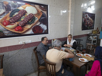 An Iranian family eats breakfast at a small restaurant in the historical city of Tabriz, located 624 km (388 miles) northwest of Tehran in t...