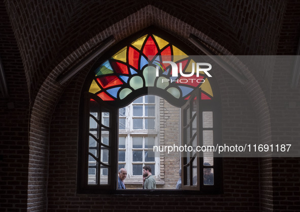 Iranian people walk past a historical mosque in the historical city of Tabriz, located 624 km (388 miles) northwest of Tehran in the Eastern...