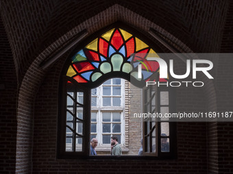 Iranian people walk past a historical mosque in the historical city of Tabriz, located 624 km (388 miles) northwest of Tehran in the Eastern...