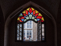 Iranian people walk past a historical mosque in the historical city of Tabriz, located 624 km (388 miles) northwest of Tehran in the Eastern...