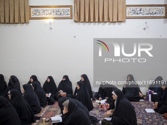 Veiled Iranian women in black chadors participate in an Islamic psychology class held at a mosque in the historical city of Tabriz, Iran, on...