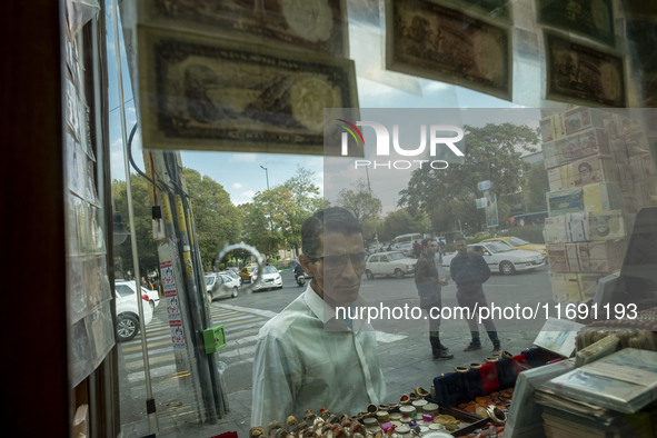 An Iranian man looks at a currency exchange shop window in the historical city of Tabriz, Iran, on October 17, 2024. 