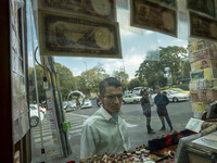 An Iranian man looks at a currency exchange shop window in the historical city of Tabriz, Iran, on October 17, 2024. (